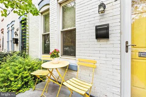 a balcony with table and chairs