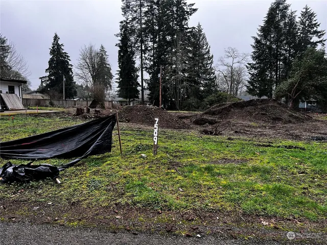 a backyard of a house with table and chairs