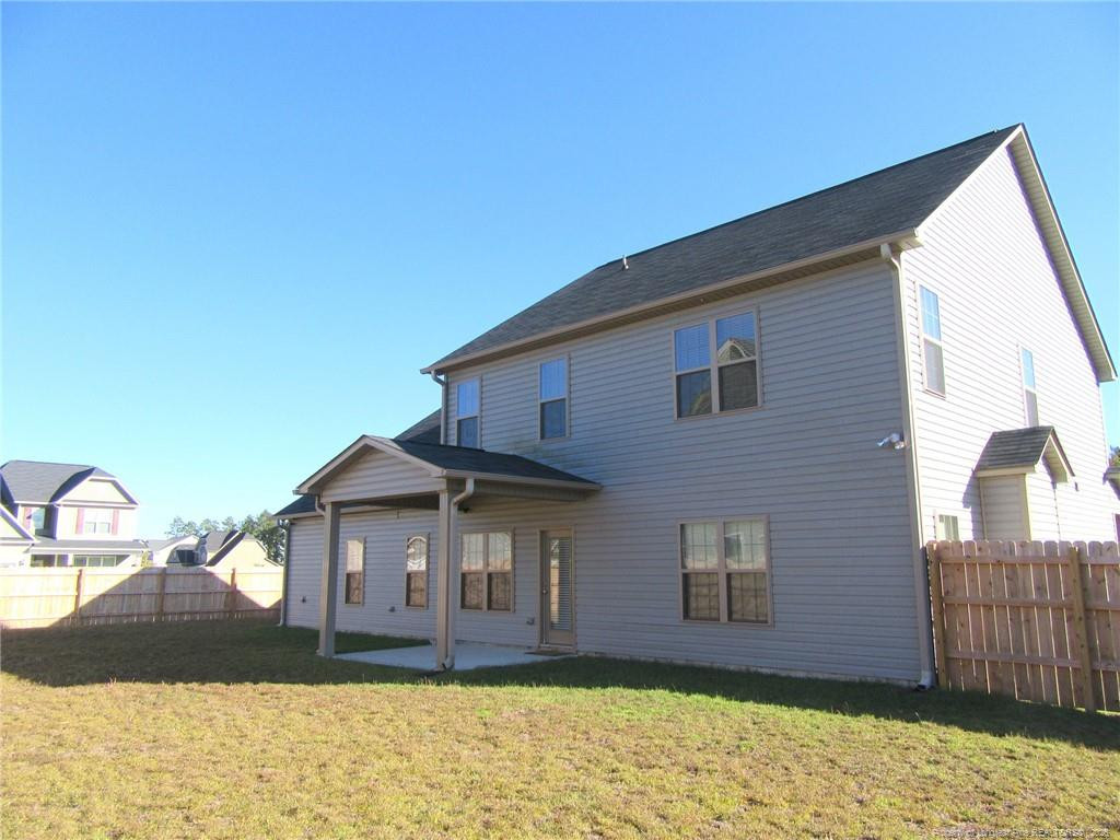 2142 Yates Ranch Road Hope Mills, NC 28348 - Photo 2 of 32 a front view of a house with a yard