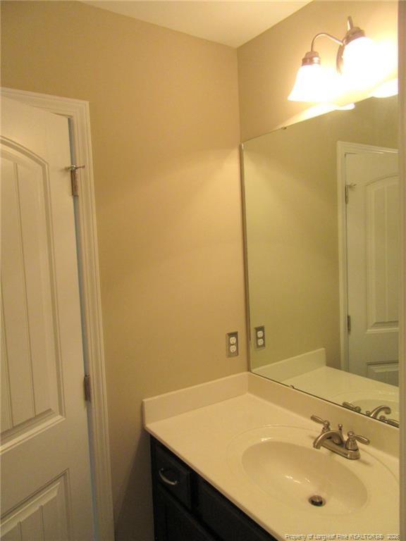 2142 Yates Ranch Road Hope Mills, NC 28348 - Photo 28 of 32 a bathroom with a sink and a mirror