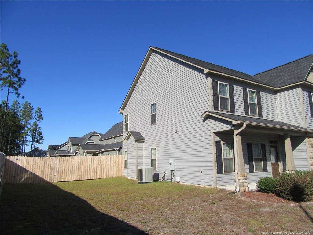 2142 Yates Ranch Road Hope Mills, NC 28348 - Photo 5 of 32 a front view of a house with a yard