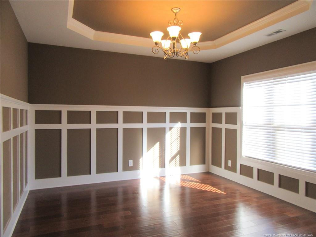 2142 Yates Ranch Road Hope Mills, NC 28348 - Photo 9 of 32 a view of an empty room with wooden floor and a window