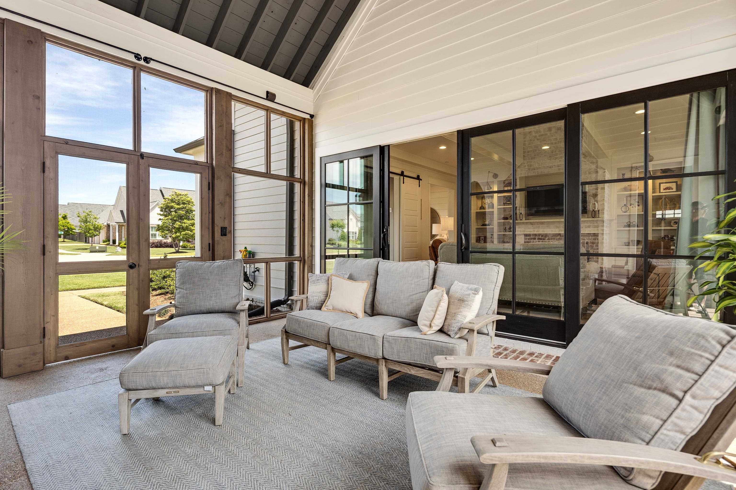 100 Sunflower View Road Piperton, TN 38017 - Photo 29 of 29 Screened porch featuring a vaulted ceiling with dark wood beams, white paneled walls, and a light-colored concrete floor