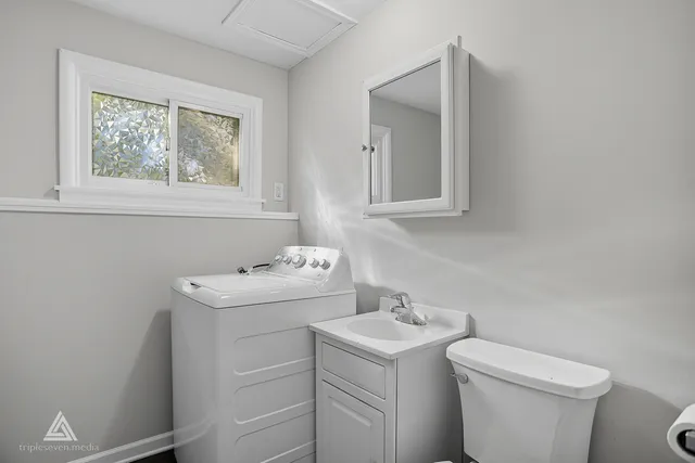 a view of bathroom with a sink and a toilet