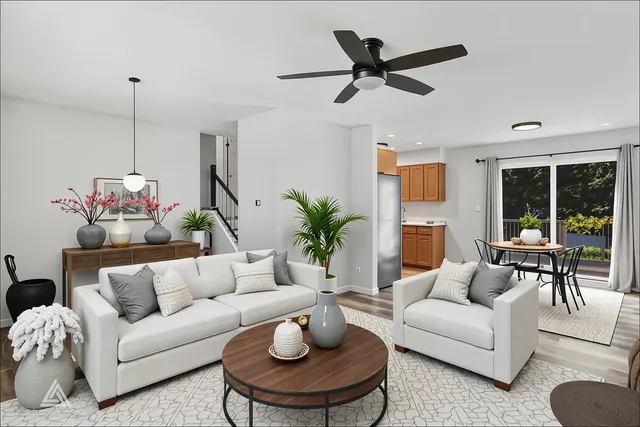 a living room with furniture and a potted plant