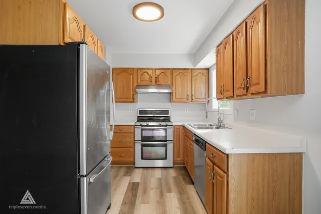 a kitchen with a refrigerator stove and sink