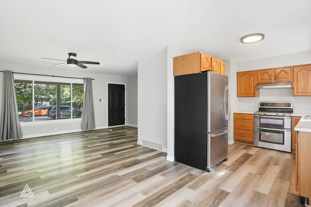 a kitchen with stainless steel appliances granite countertop a refrigerator and a stove