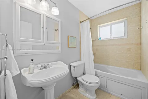 a white toilet sitting next to a bathroom sink