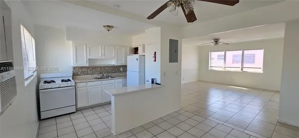 a kitchen with cabinets and window