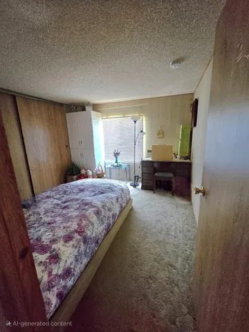 a bed room with a bed and a chair