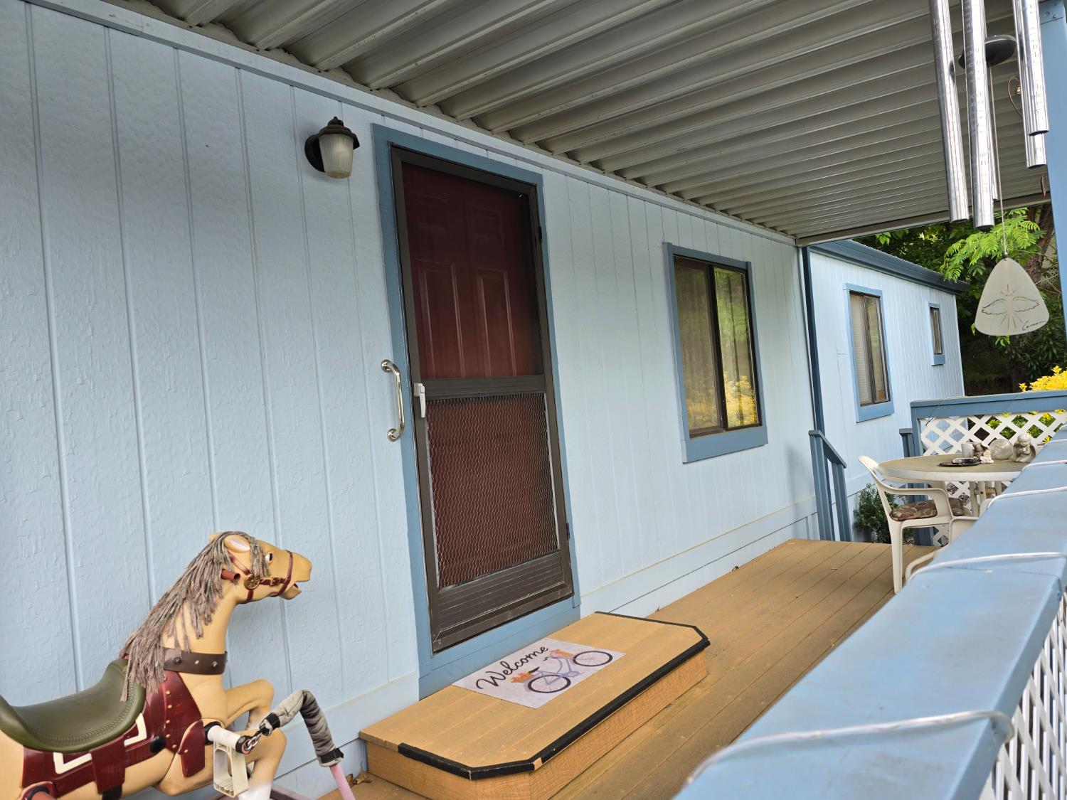 18717 Mill Villa Road, Unit 122 Jamestown, CA 95327 - Photo 4 of 14 a living room with a table and a chandelier