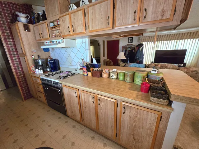 a kitchen with stainless steel appliances granite countertop a stove and a sink