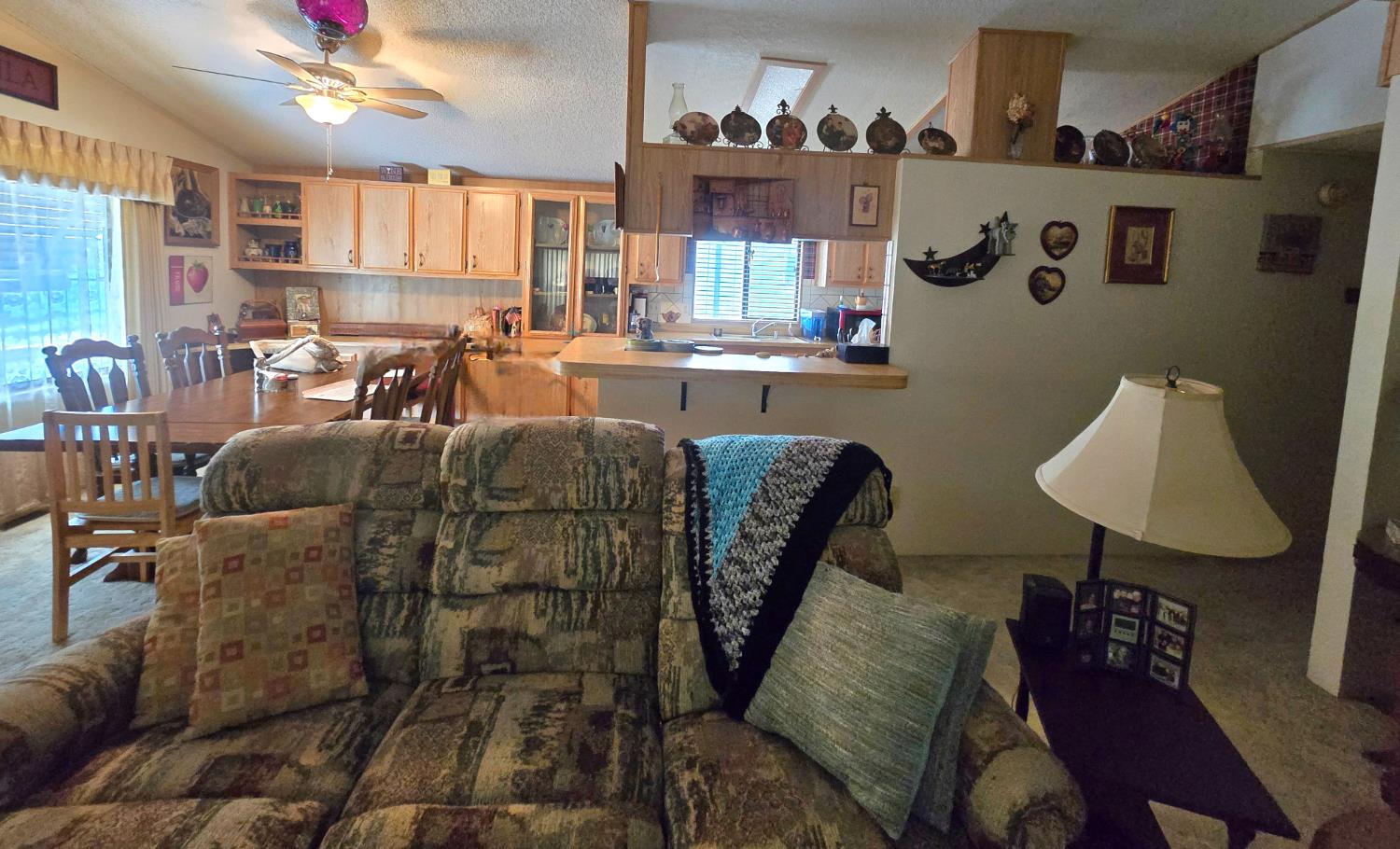 18717 Mill Villa Road, Unit 122 Jamestown, CA 95327 - Photo 9 of 14 a living room with furniture and a chandelier