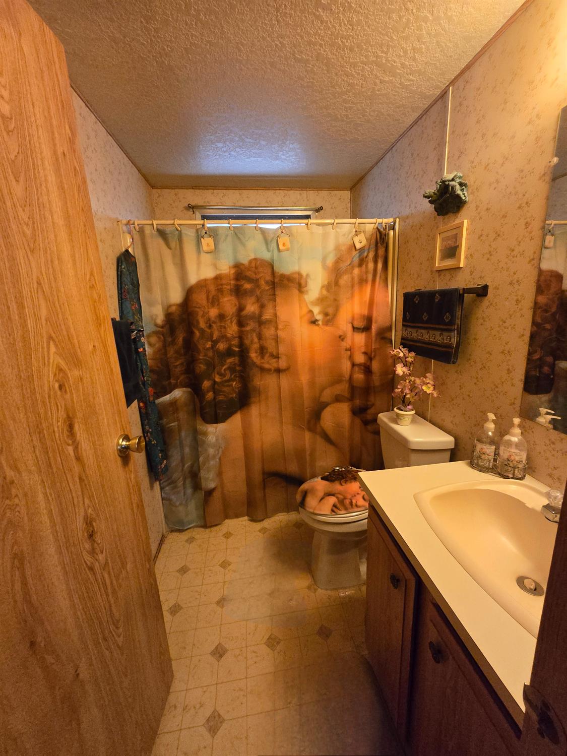 18717 Mill Villa Road, Unit 122 Jamestown, CA 95327 - Photo 10 of 14 a bathroom with a sink and mirror