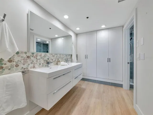 a living room with a black white couch and a potted plant