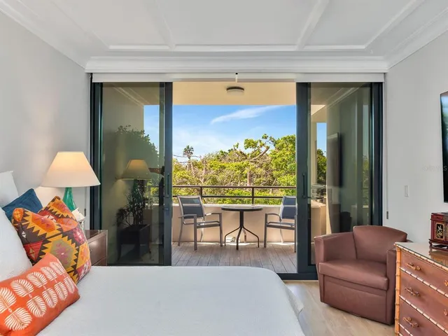 a dining room with furniture and a floor to ceiling window