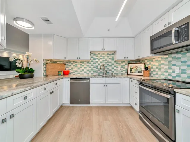 a living room with furniture a rug and a large window