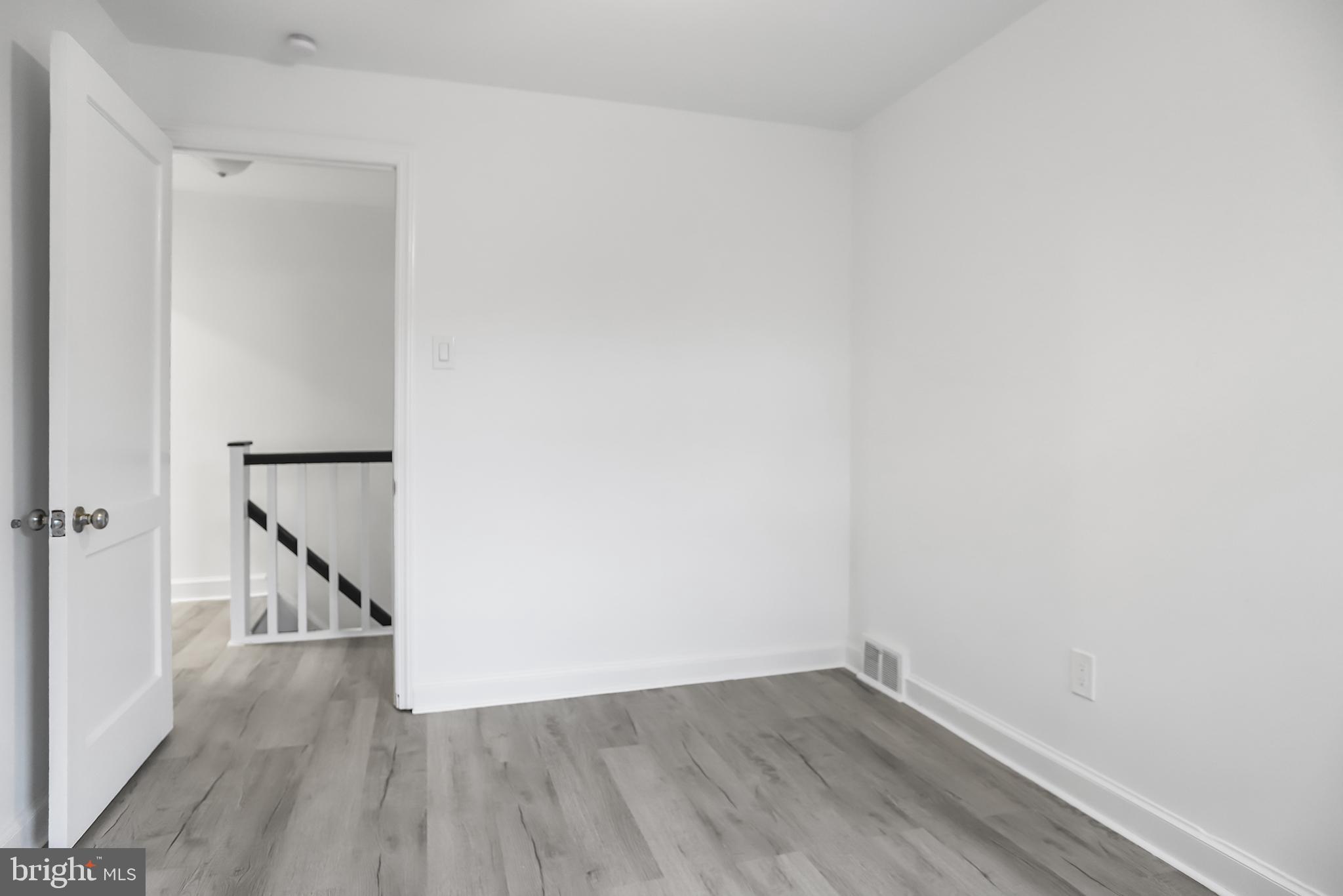 1913 Winton Avenue Havertown, PA 19083 - Photo 13 of 17 a view of an empty room with wooden floor and a window