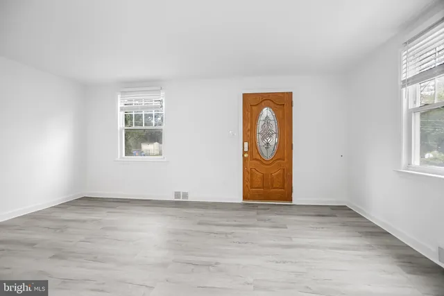 an empty room with windows and closet