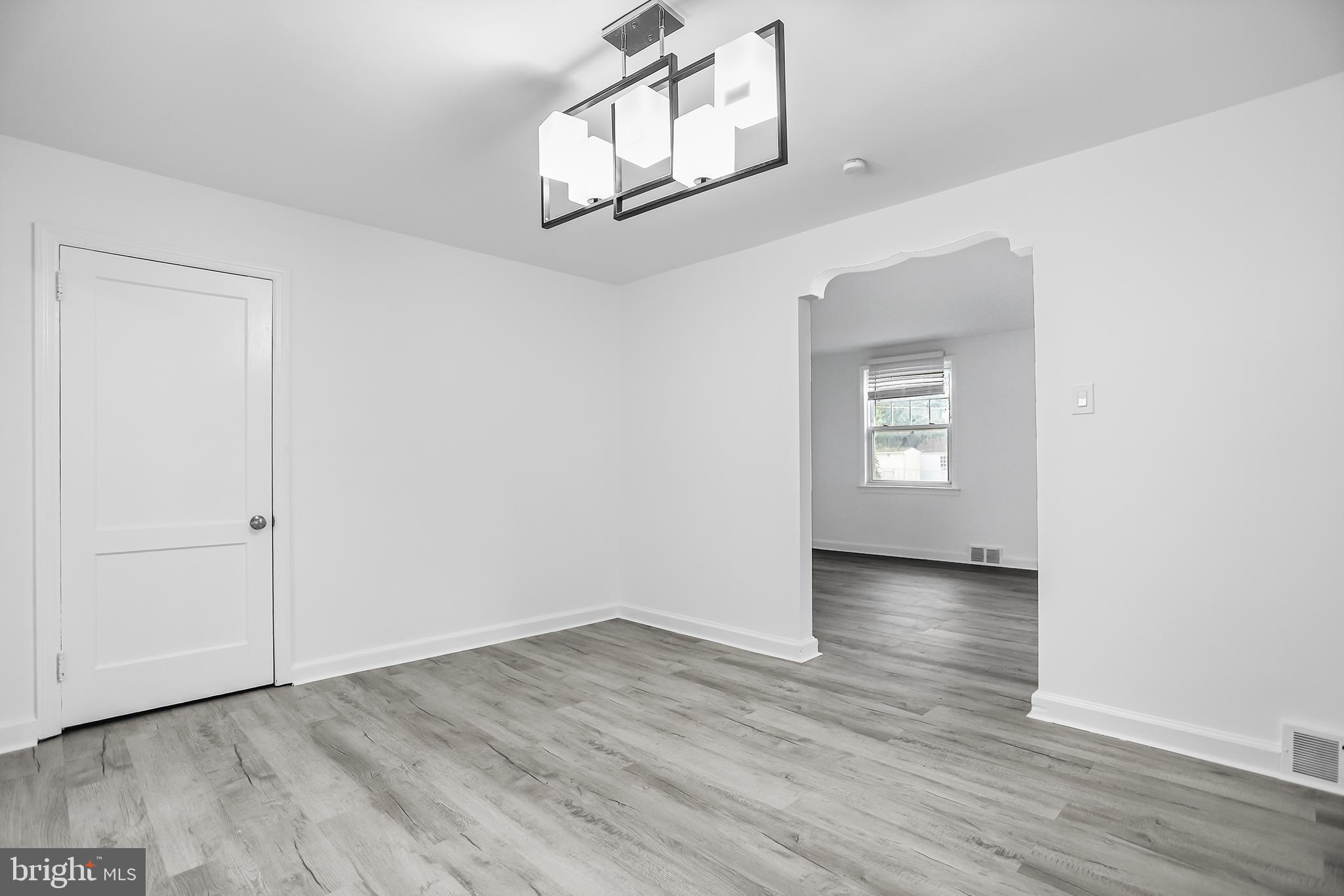 1913 Winton Avenue Havertown, PA 19083 - Photo 6 of 17 a view of an empty room with wooden floor and a window