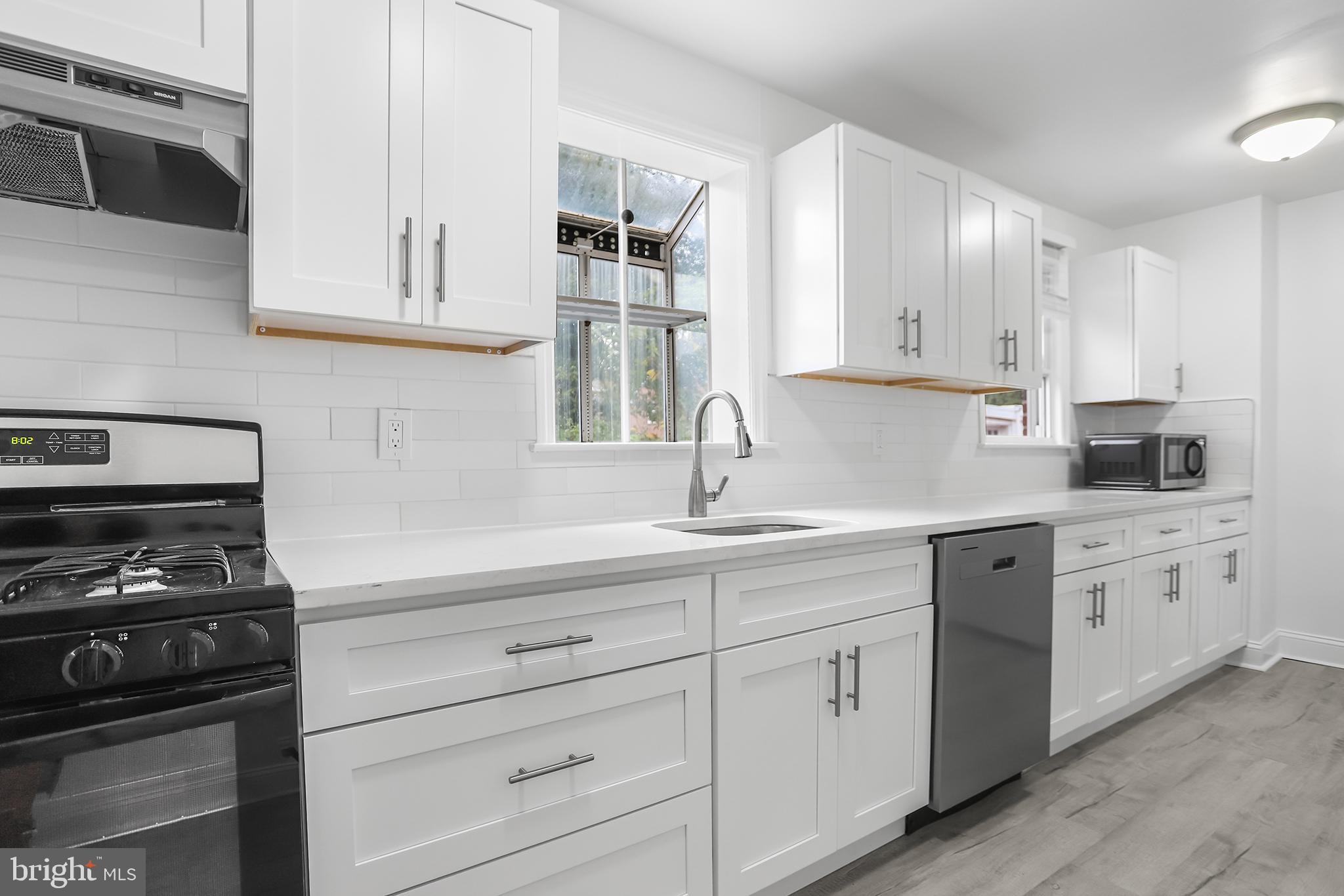 1913 Winton Avenue Havertown, PA 19083 - Photo 7 of 17 a kitchen with white cabinets and white appliances