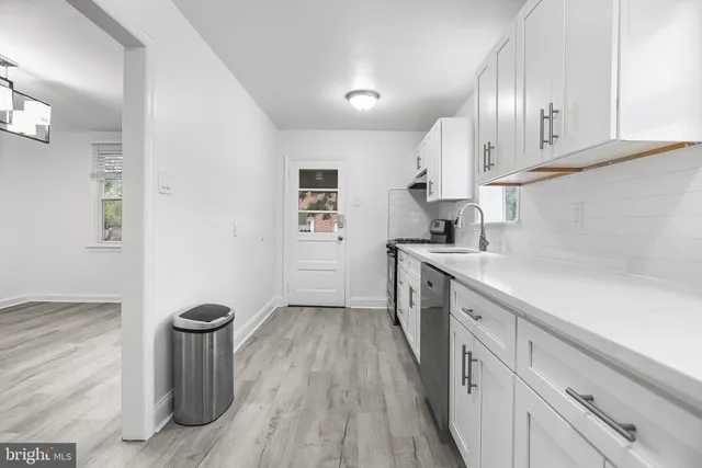 a kitchen with sink cabinets and window