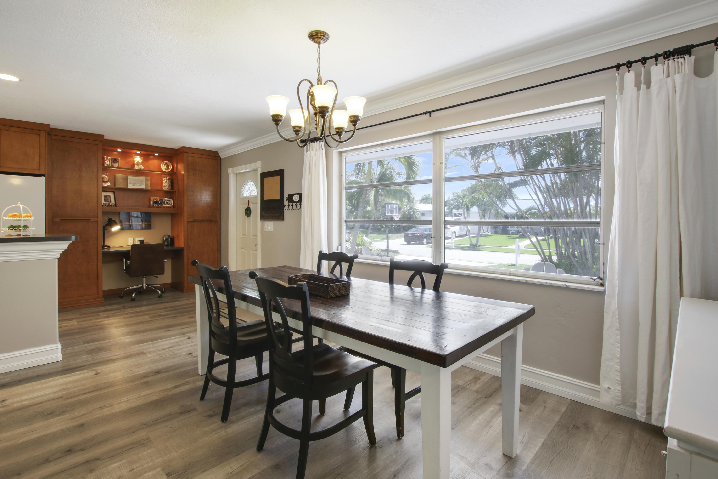 361 Mars Avenue Tequesta, FL 33469 - Photo 15 of 28 a view of a dining room with furniture window and wooden floor
