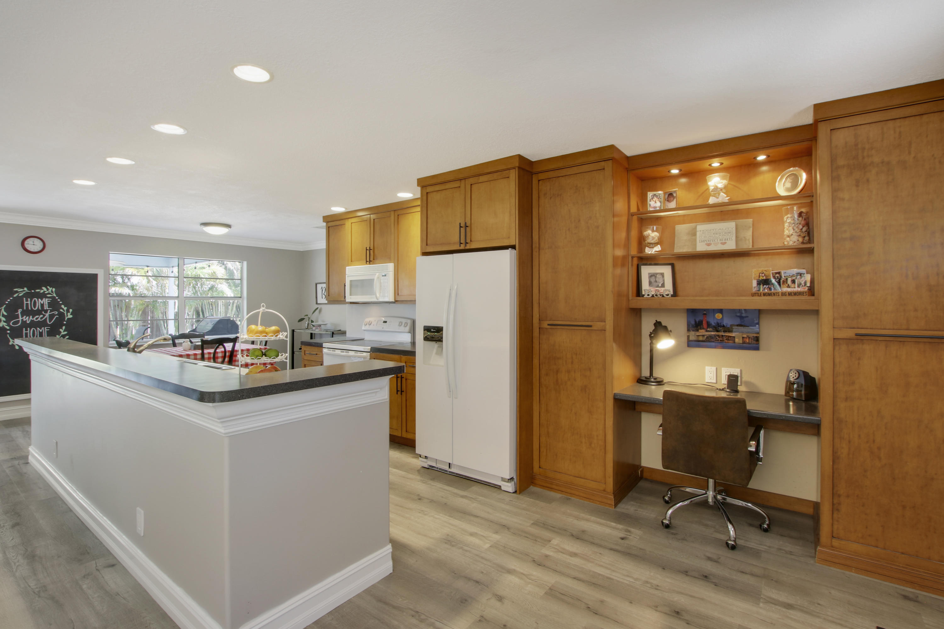 361 Mars Avenue Tequesta, FL 33469 - Photo 5 of 28 a kitchen with sink cabinets and refrigerator