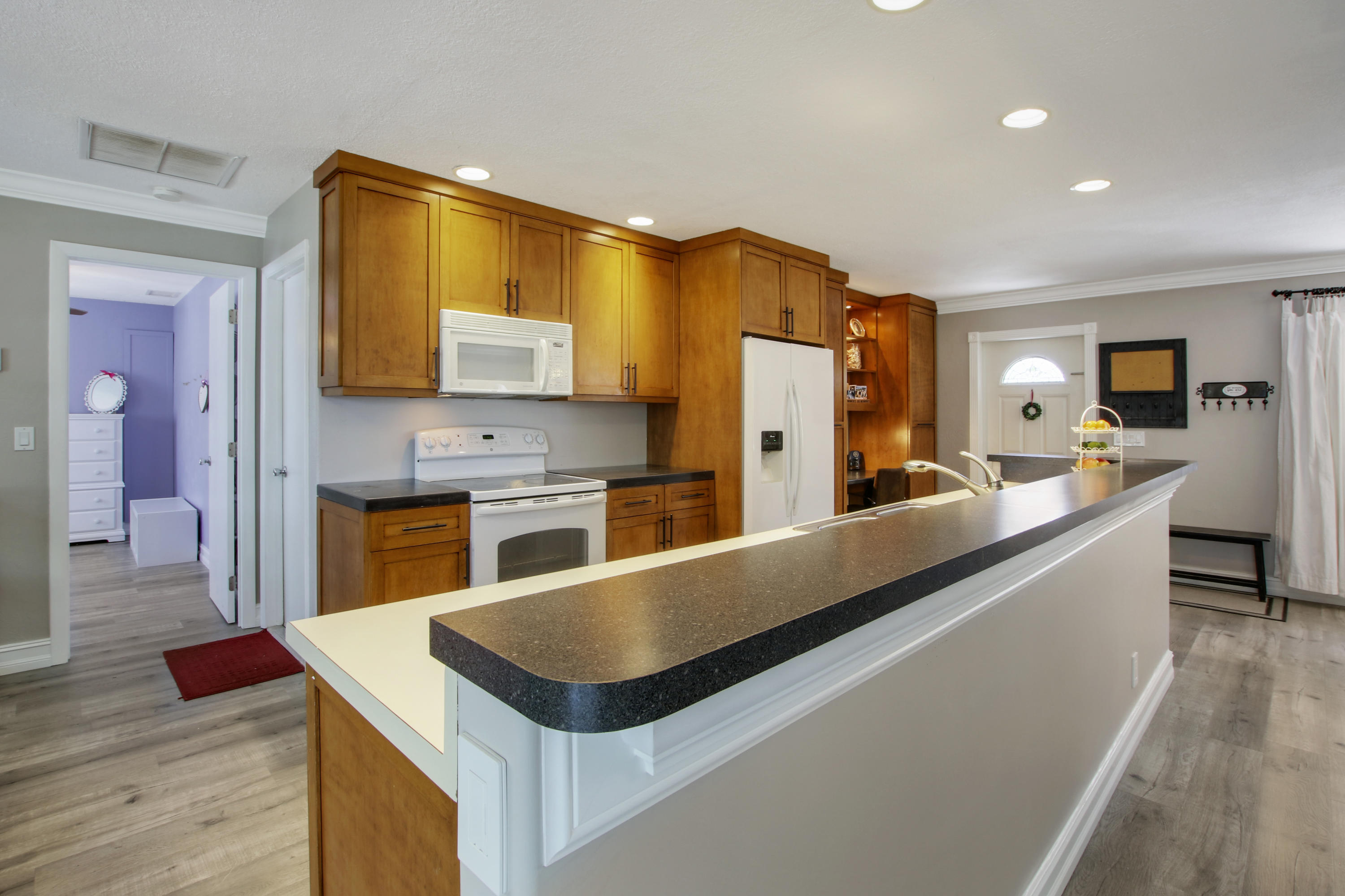 361 Mars Avenue Tequesta, FL 33469 - Photo 7 of 28 a kitchen with stainless steel appliances a sink and a refrigerator