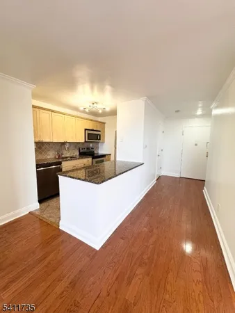 a view of kitchen with refrigerator stove microwave and cabinets