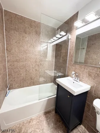 a bathroom with a sink mirror toilet and bathtub