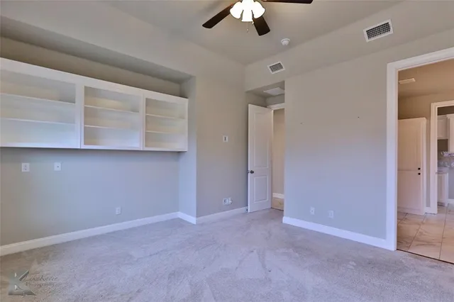 an empty room with a empty space and a ceiling fan
