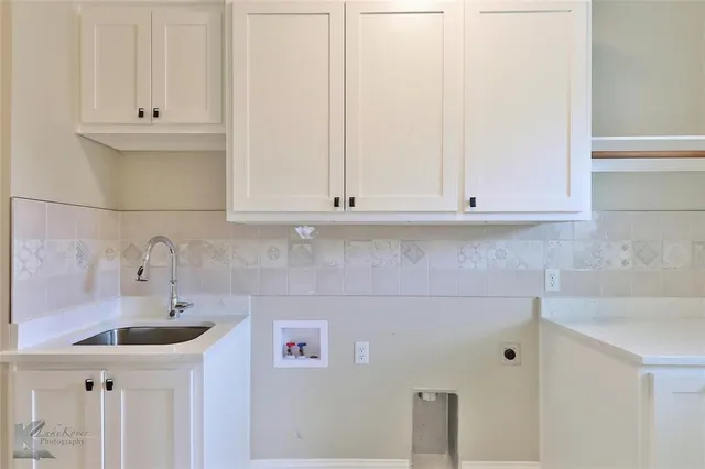 a bathroom with a sink and cabinets