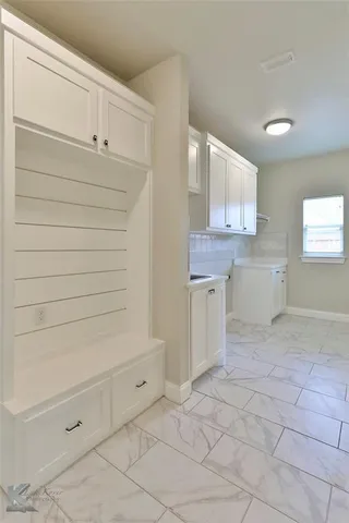 a view of a closet and utility room