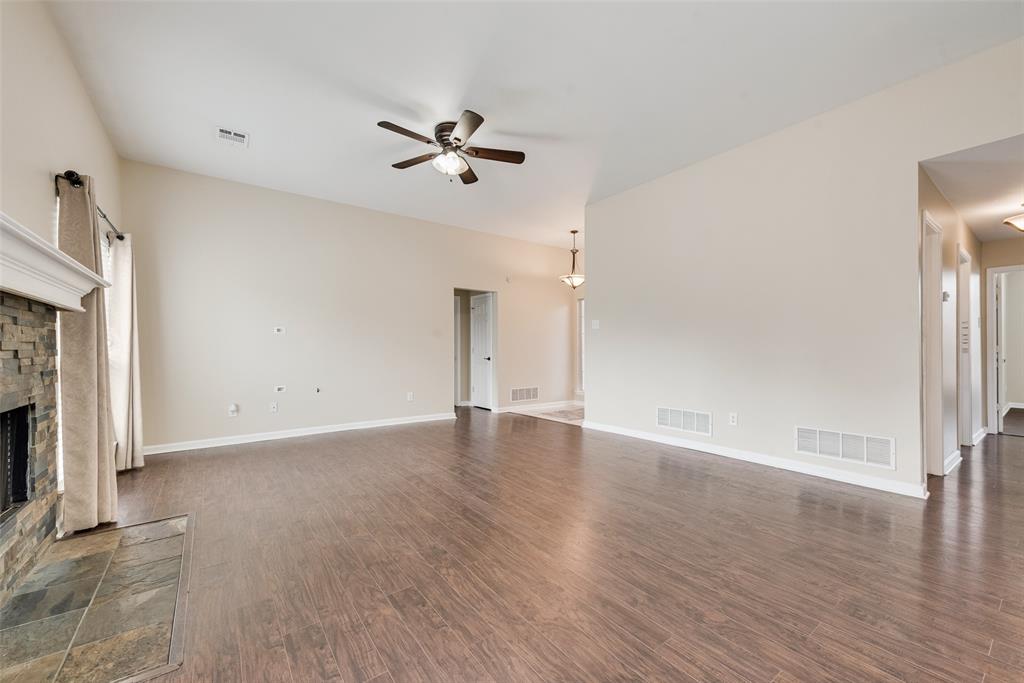 526 Morningside Court Midlothian, TX 76065 - Photo 12 of 28 a view of an empty room with wooden floor and a fireplace