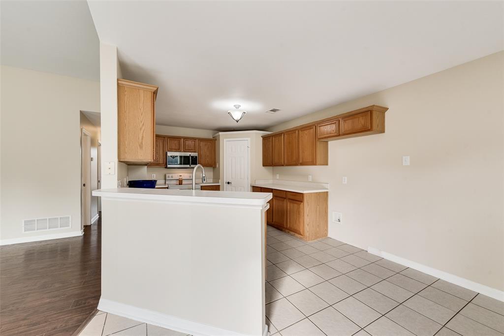 526 Morningside Court Midlothian, TX 76065 - Photo 15 of 28 a kitchen with stainless steel appliances a refrigerator and a stove top oven