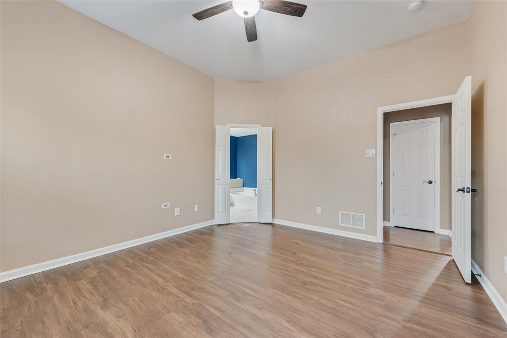 526 Morningside Court Midlothian, TX 76065 - Photo 18 of 28 a view of an empty room with wooden floor a ceiling fan and window