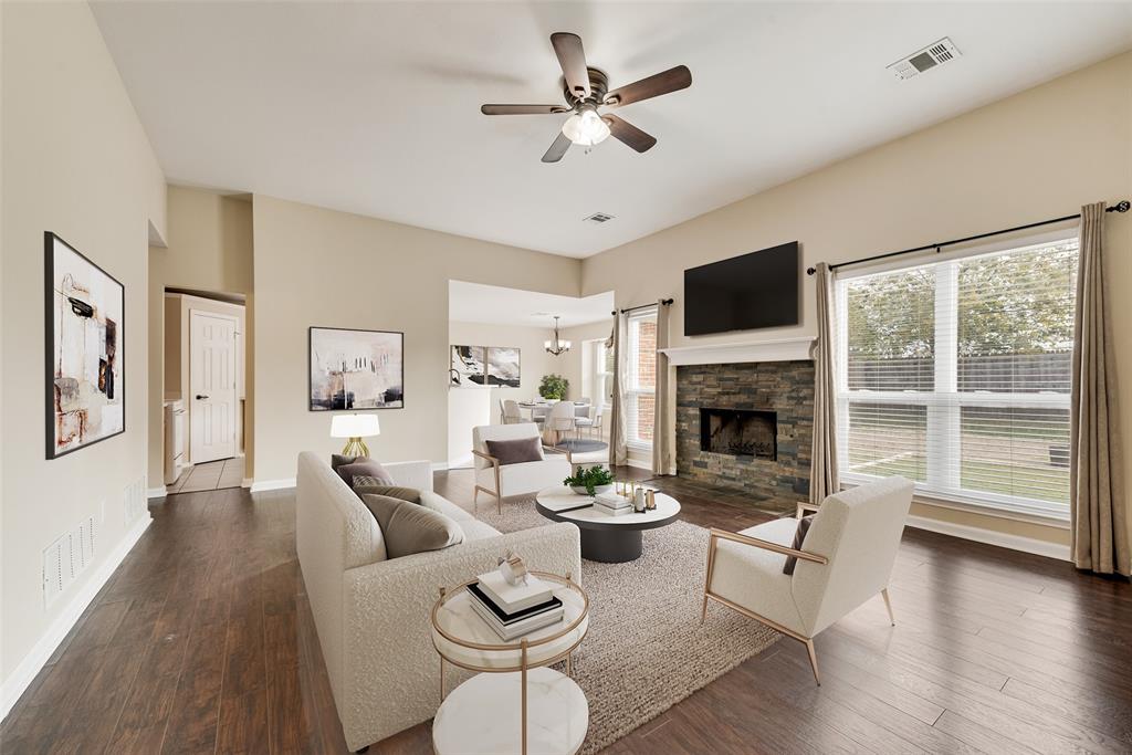 526 Morningside Court Midlothian, TX 76065 - Photo 3 of 28 a living room with furniture a fireplace and a flat screen tv