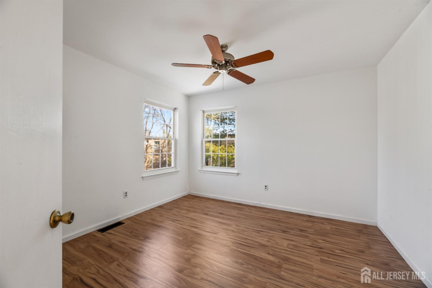 95 Lawrence Street New Brunswick, NJ 08901 - Photo 11 of 25 wooden floor in an empty room with a window
