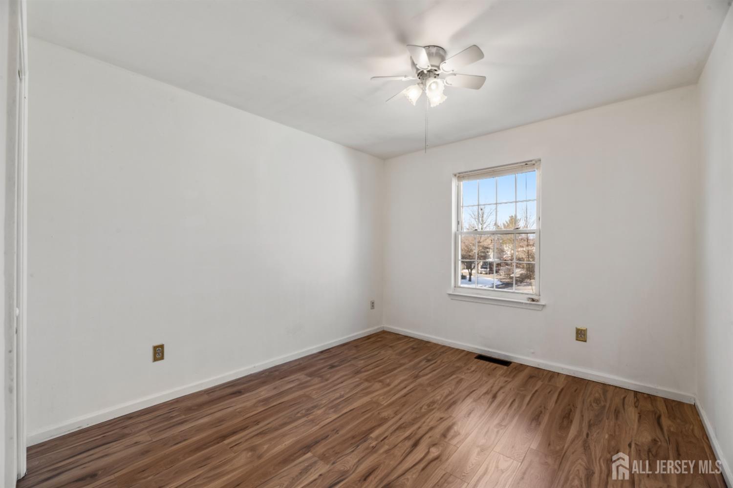 95 Lawrence Street New Brunswick, NJ 08901 - Photo 13 of 25 wooden floor in an empty room with a window