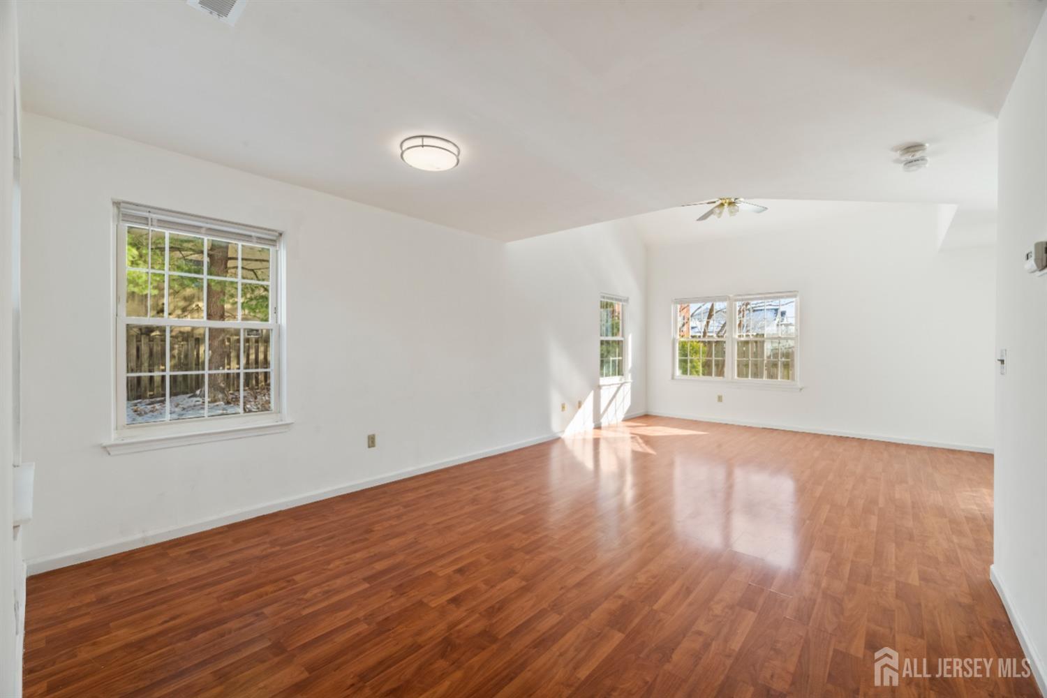 95 Lawrence Street New Brunswick, NJ 08901 - Photo 3 of 25 an empty room with wooden floor and windows