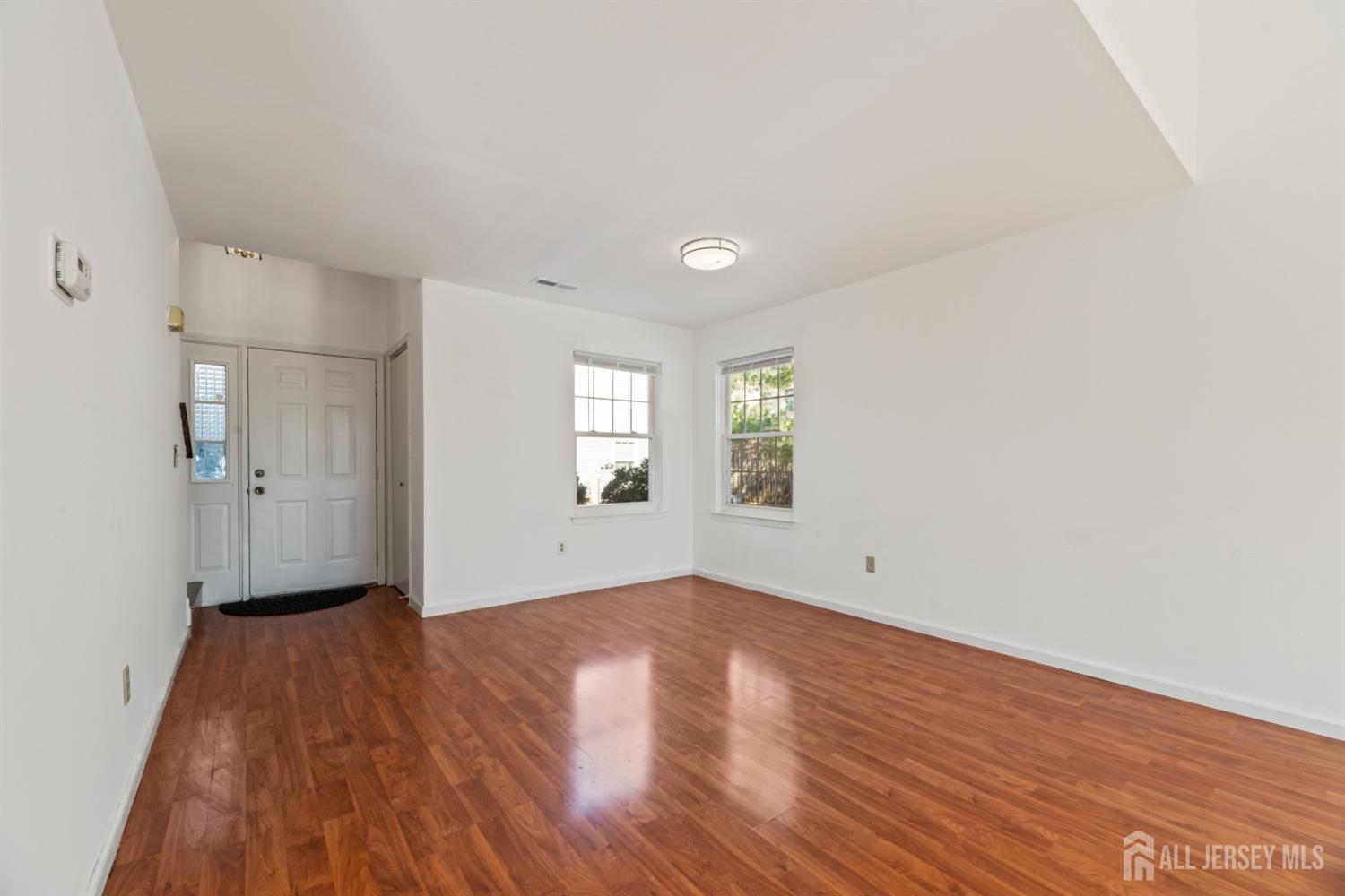 95 Lawrence Street New Brunswick, NJ 08901 - Photo 4 of 25 a view of empty room with wooden floor and fan