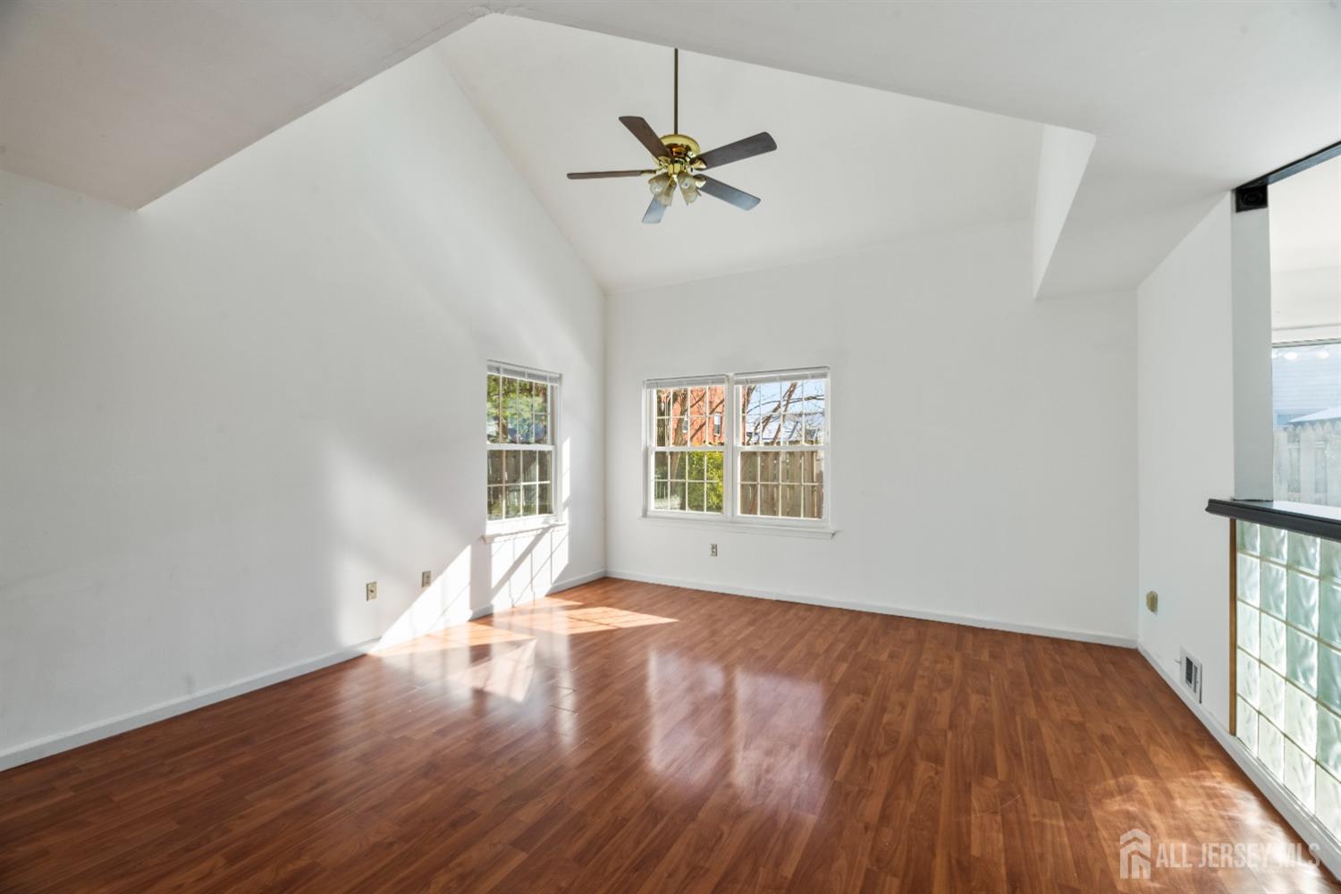 95 Lawrence Street New Brunswick, NJ 08901 - Photo 5 of 25 a view of an empty room with wooden floor and a window