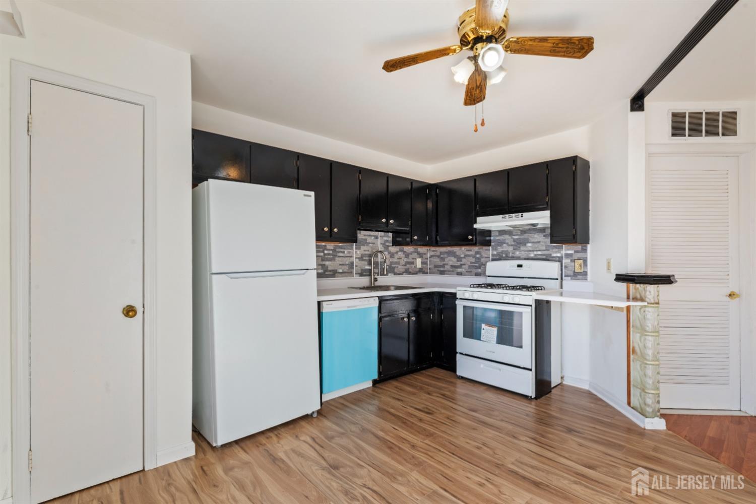 95 Lawrence Street New Brunswick, NJ 08901 - Photo 6 of 25 a kitchen with stainless steel appliances a refrigerator sink and stove