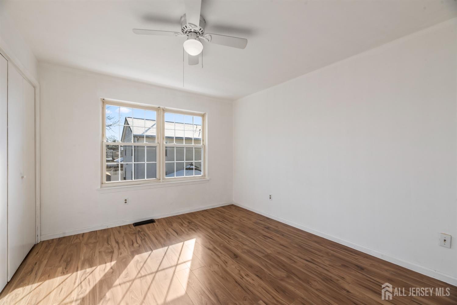 95 Lawrence Street New Brunswick, NJ 08901 - Photo 9 of 25 a view of empty room with wooden floor and fan