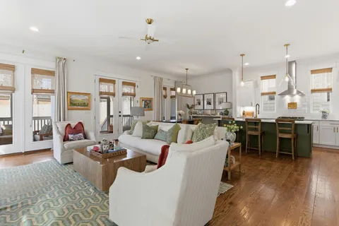 a living room with lots of furniture and kitchen view
