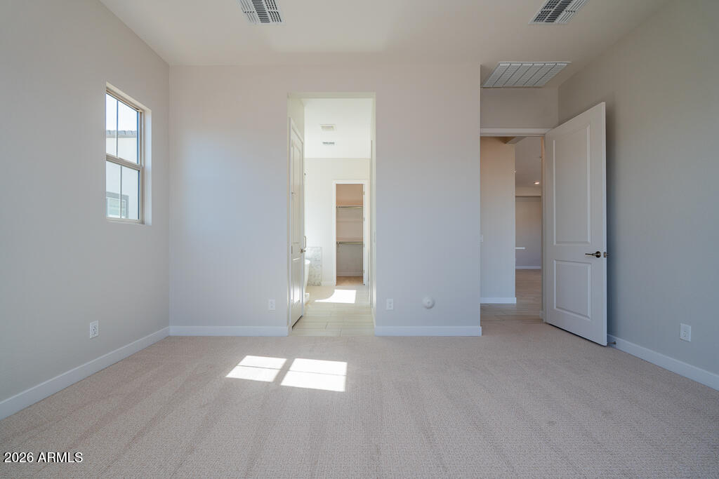 5879 South Red Rock Street Gilbert, AZ 85298 - Photo 6 of 18 a view of empty room with wooden floor and window