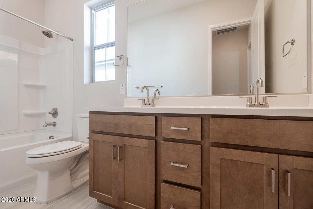 5879 South Red Rock Street Gilbert, AZ 85298 - Photo 9 of 18 a bathroom with a sink toilet and mirror