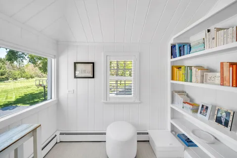 a bathroom with a toilet a sink and a window
