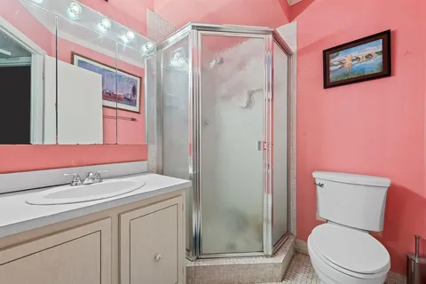 a bathroom with a sink mirror vanity and toilet